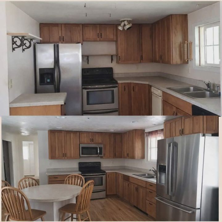 Compact kitchen with stainless steel appliances, wood cabinets, white countertops, and a small dining table and chairs