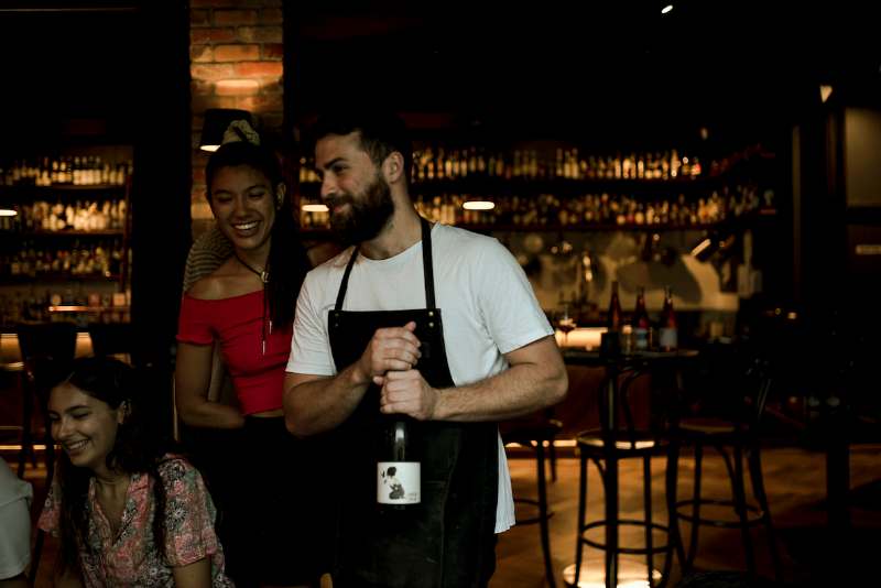 waiter bringing a wine bottle