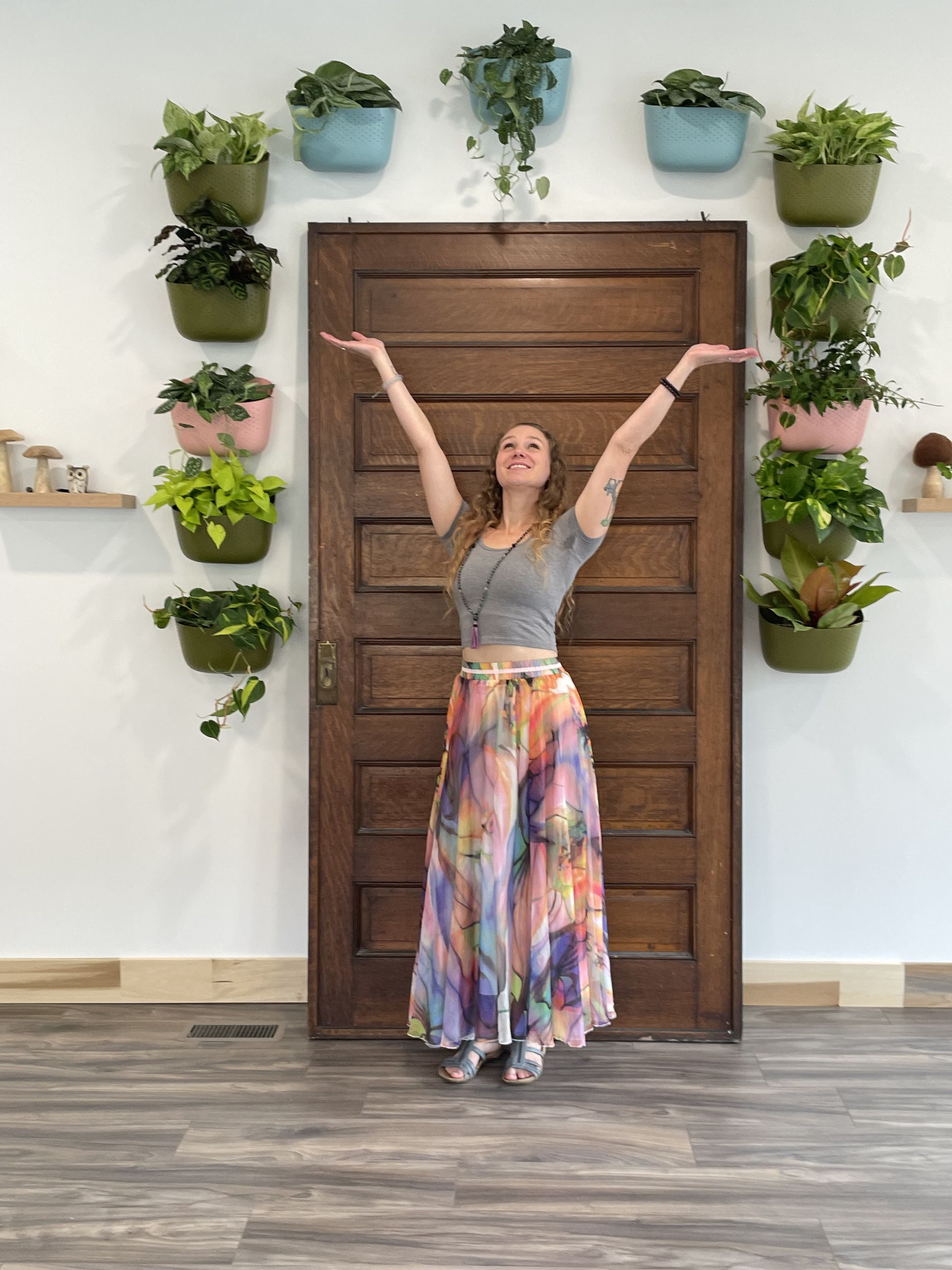 One of the Healers, Tessa standing in front of a door with her arms held high