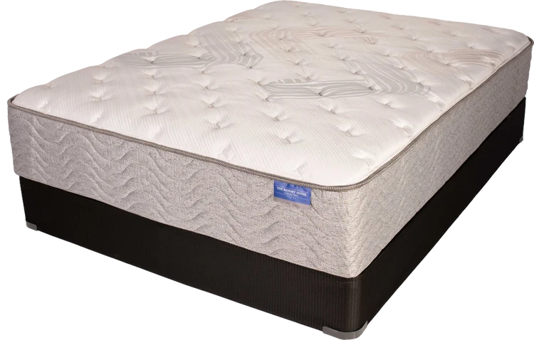 White tufted mattress with dark base on a white background