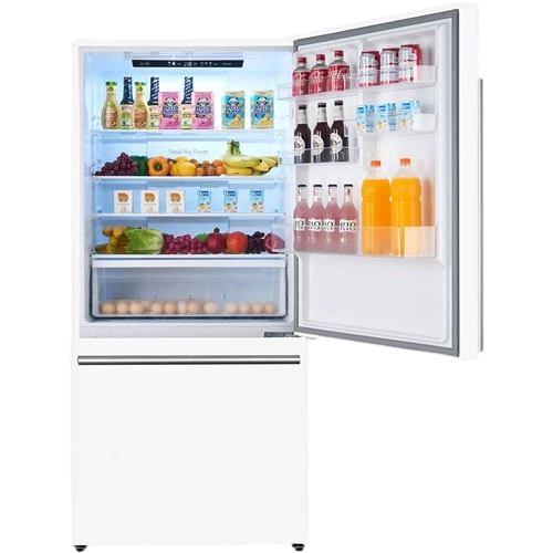 Open refrigerator filled with drinks, fruit, vegetables, and eggs, with bottles on the door shelves.