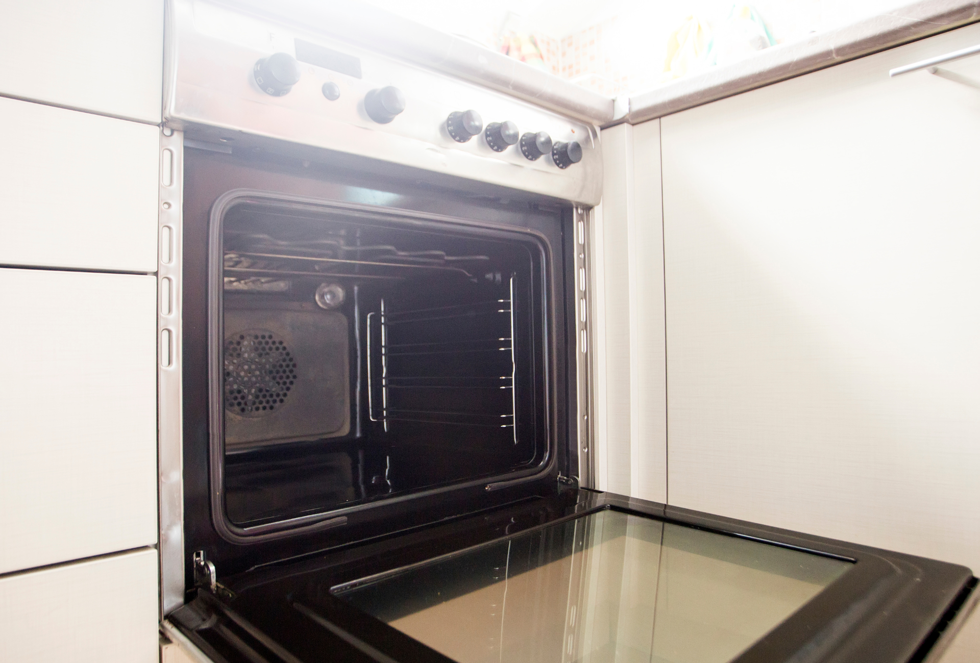 Open oven with interior racks and fan visible.
