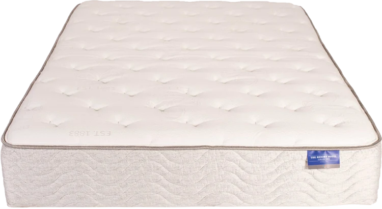 White quilted mattress with a stitched top and blue label on the side