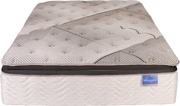 Beige patterned mattress with a dark gray edge and a small blue label on the lower right side