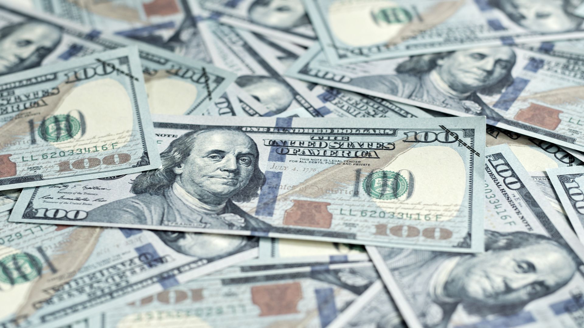 A pile of 100 dollar bills with franklin on them.