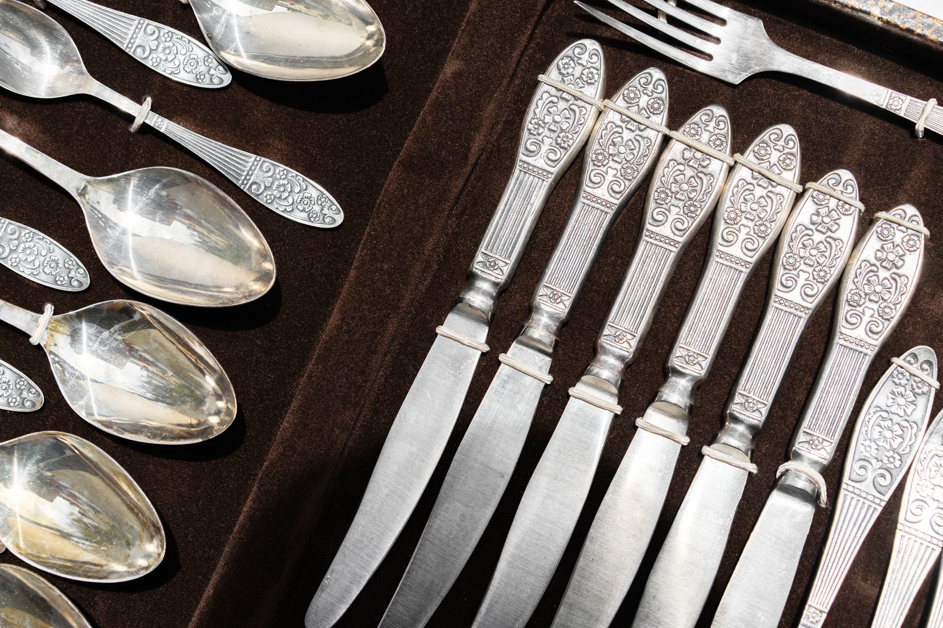 A set of silverware including knives spoons and forks