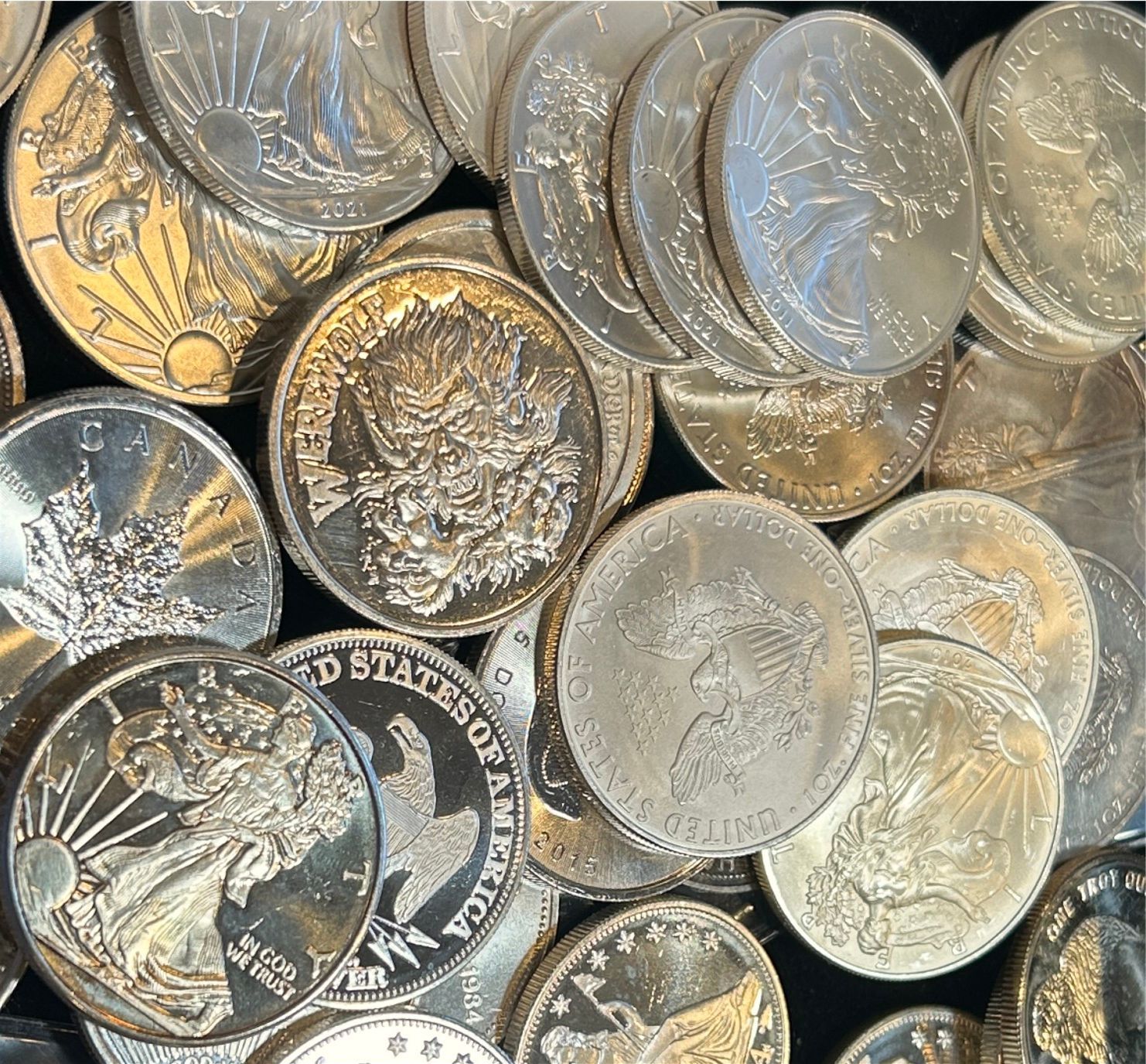 Close-up of assorted silver and gold coins piled together