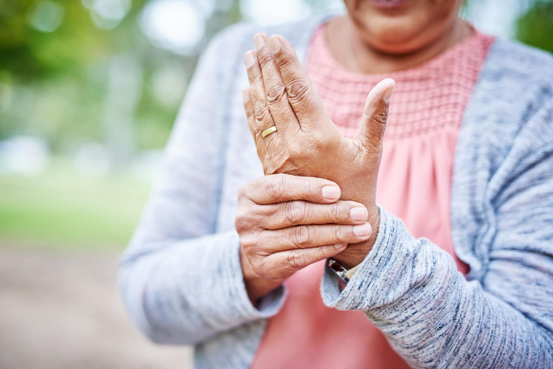 a woman holding her wrist in pain