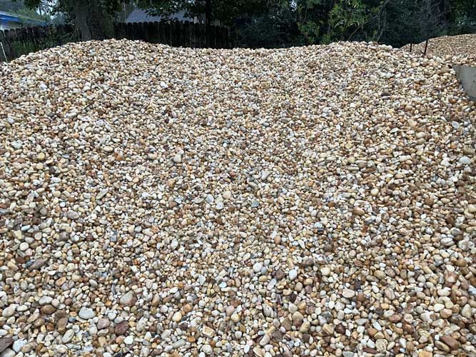 Large pile of small white and tan stones outdoors