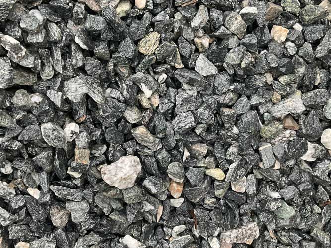 Close-up of gray and black gravel with a few lighter stones scattered throughout