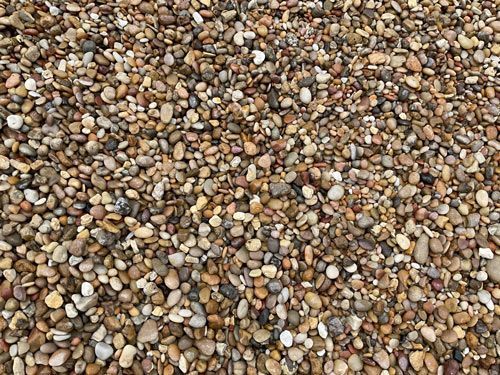 Close-up of small multicolored pebbles and gravel covering the ground