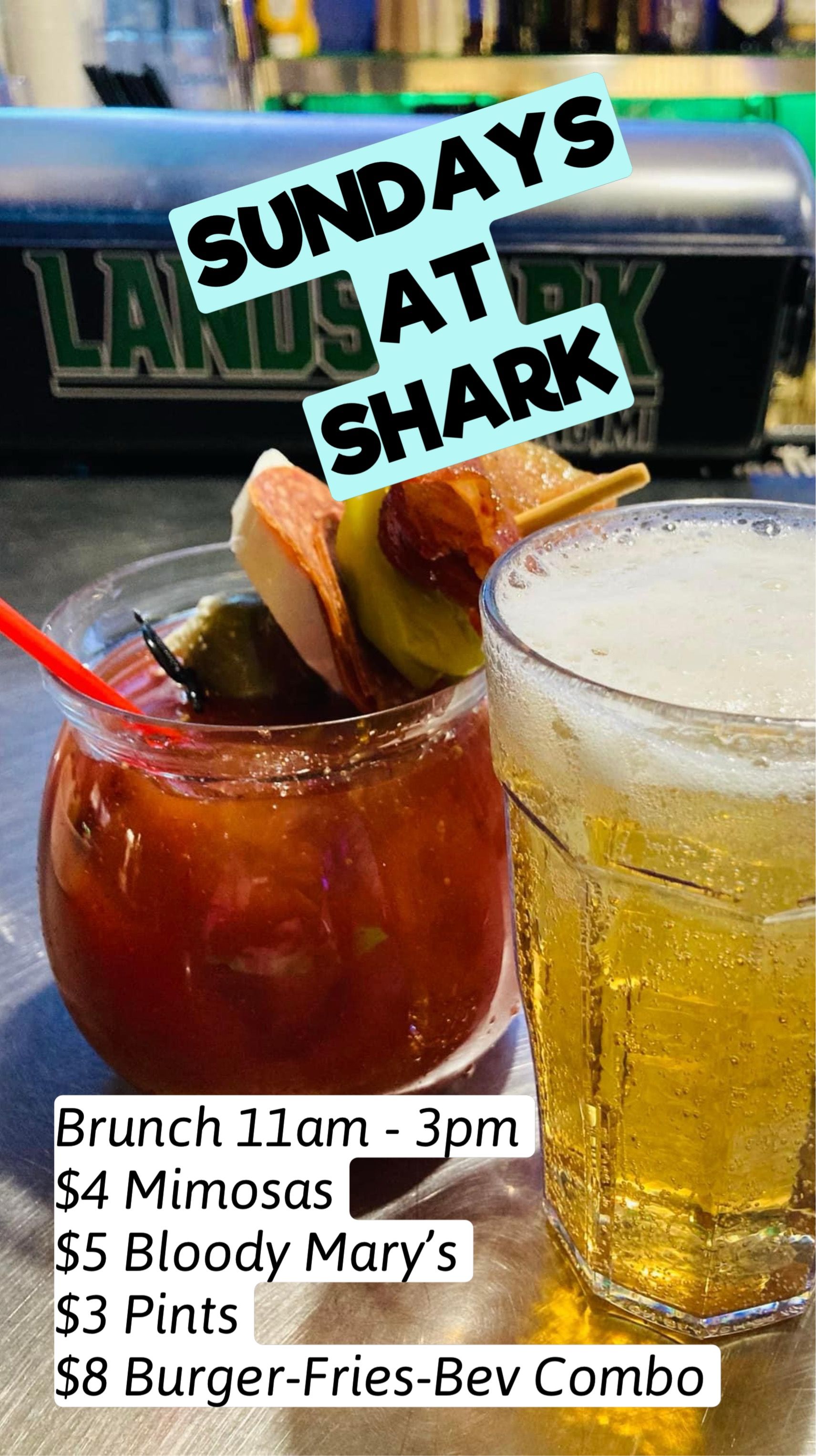 Sunday’s at Shark: cocktails and beer specials sign with drinks on a bar counter