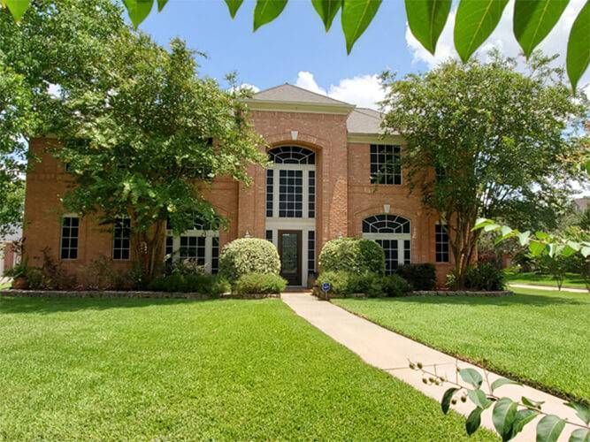 Affluent brick home with Lone Star Solar Screens