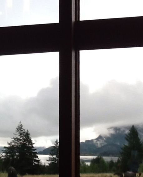 A window with a view of mountains and trees