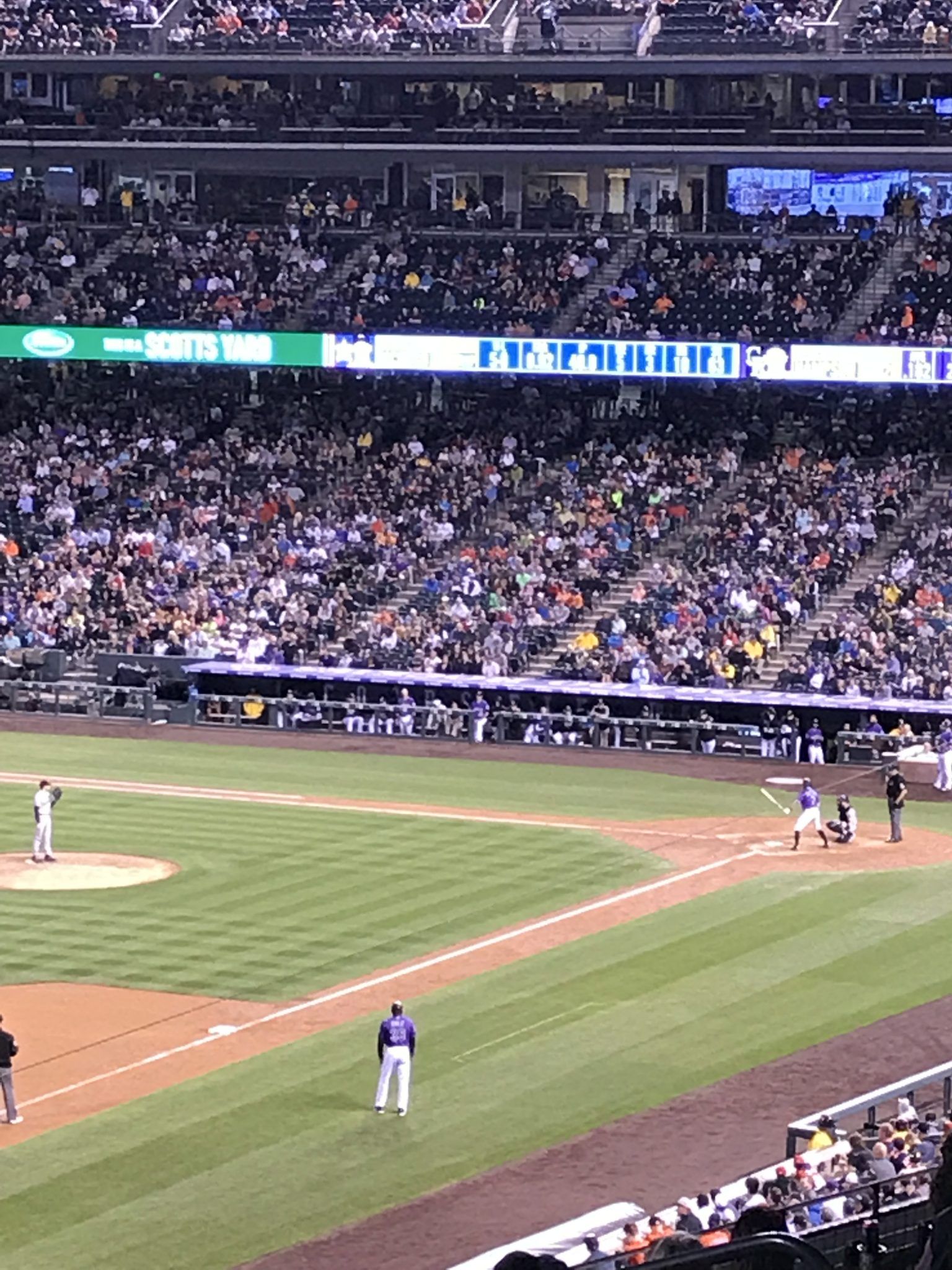 A baseball game is being played in a stadium with a large crowd watching.