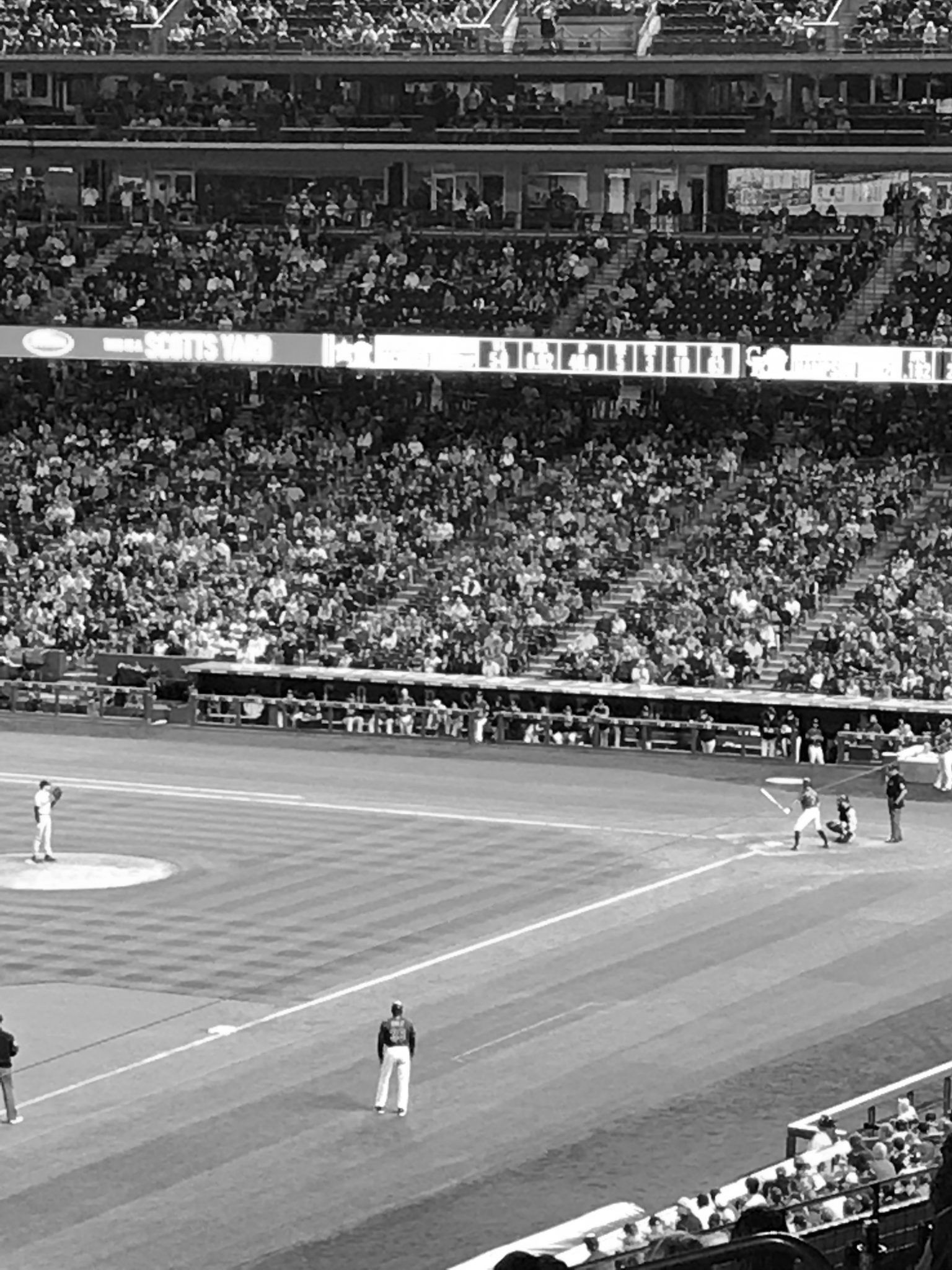A black and white photo of a baseball game in a stadium