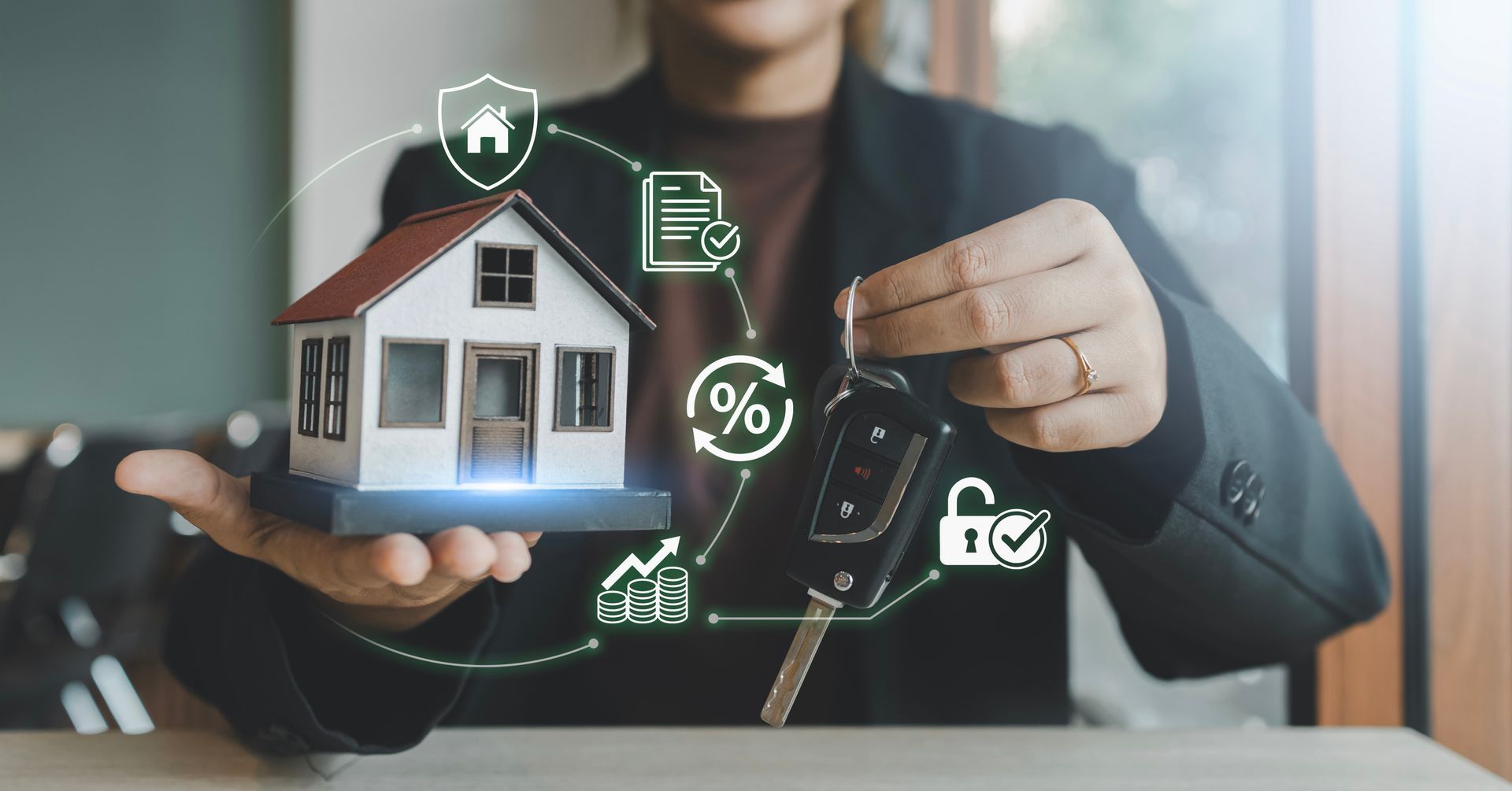 Hands holding a house model and car key with bundled home and auto insurance icons