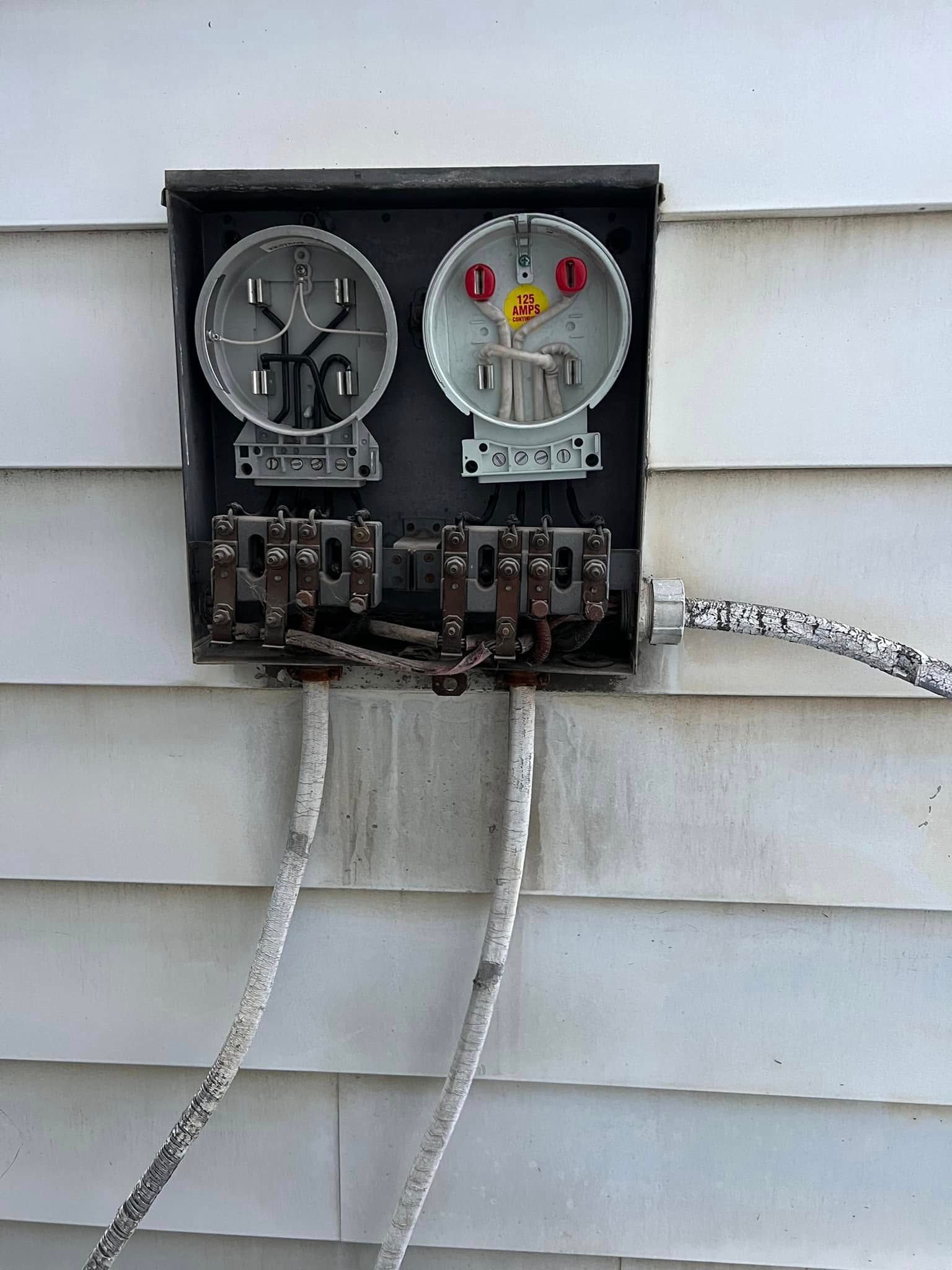 A electrical box on the side of a house with a smiley face on it