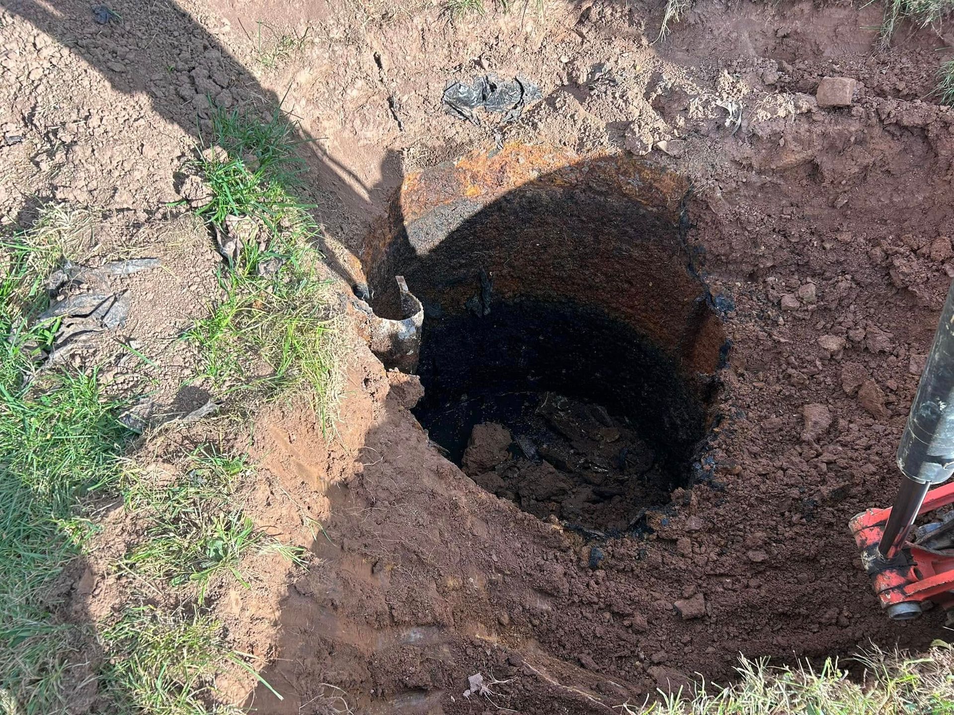 A person is digging a hole in the ground with a shovel.