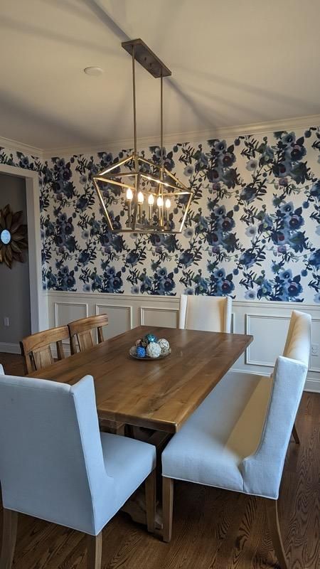 A dining room with a table and chairs and a chandelier.