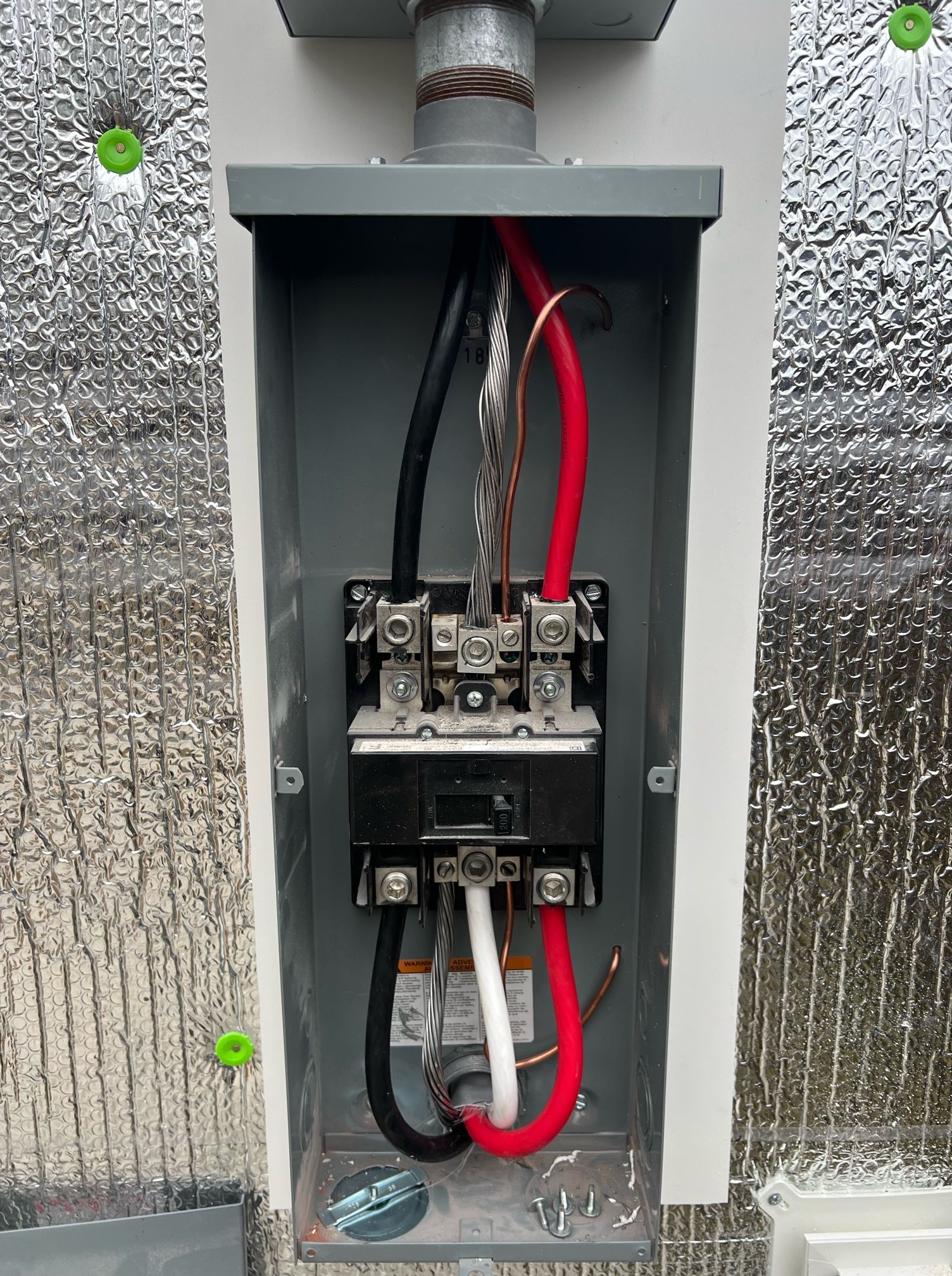 A close up of a electrical box with wires coming out of it.