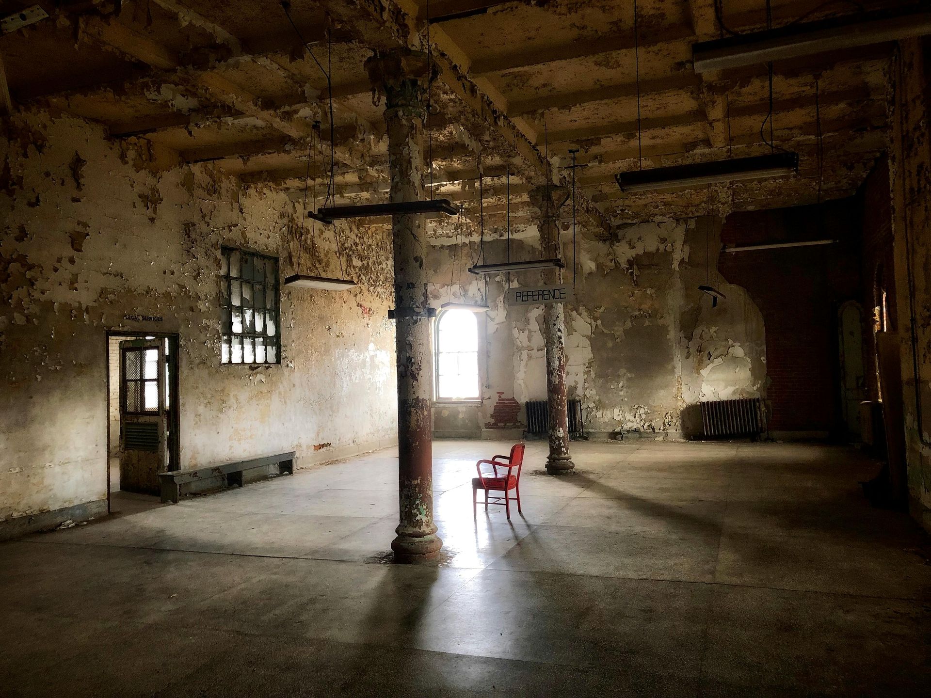 Sunlight streams through a window, illuminating the chair and dust motes.
