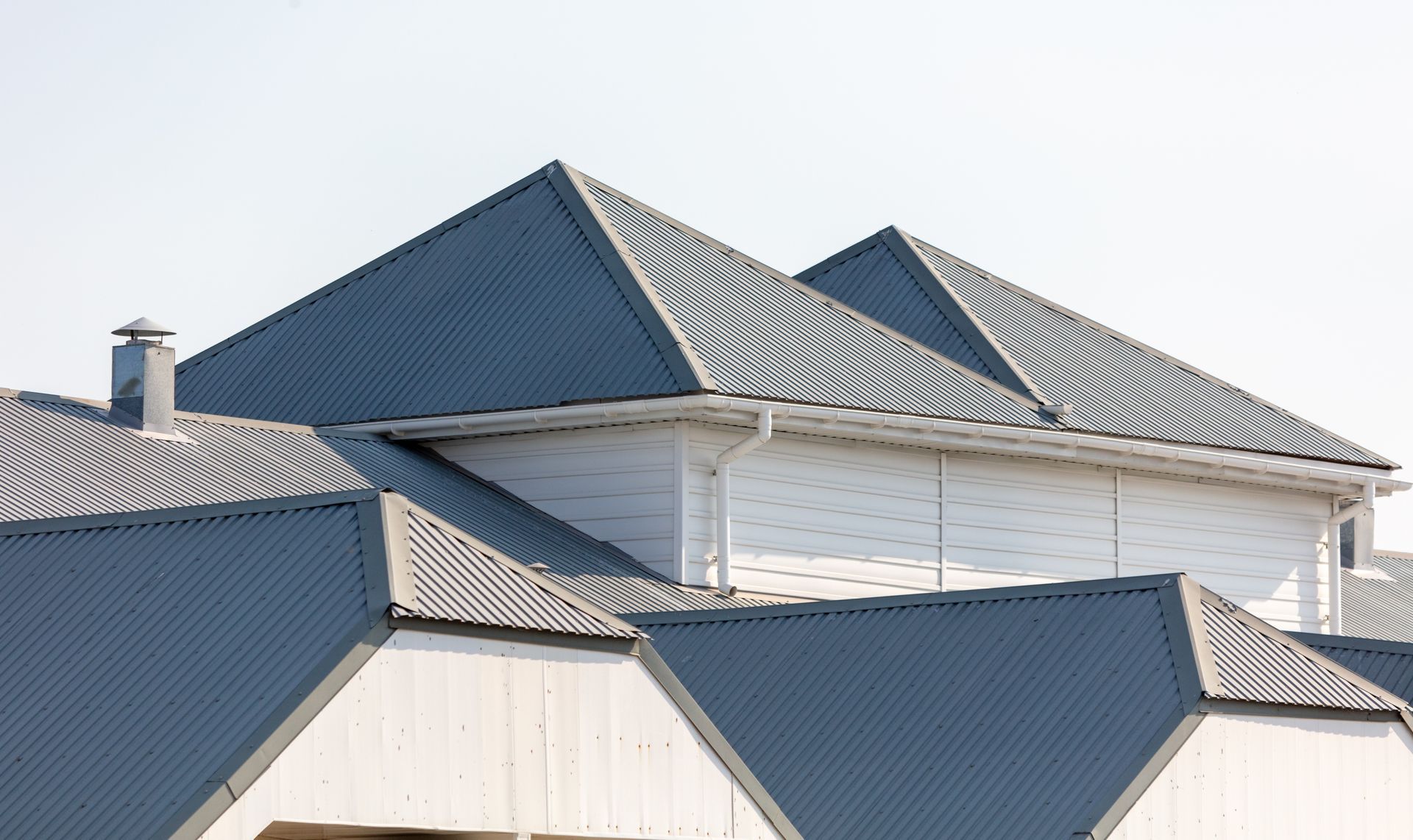 A house with a blue roof and white siding