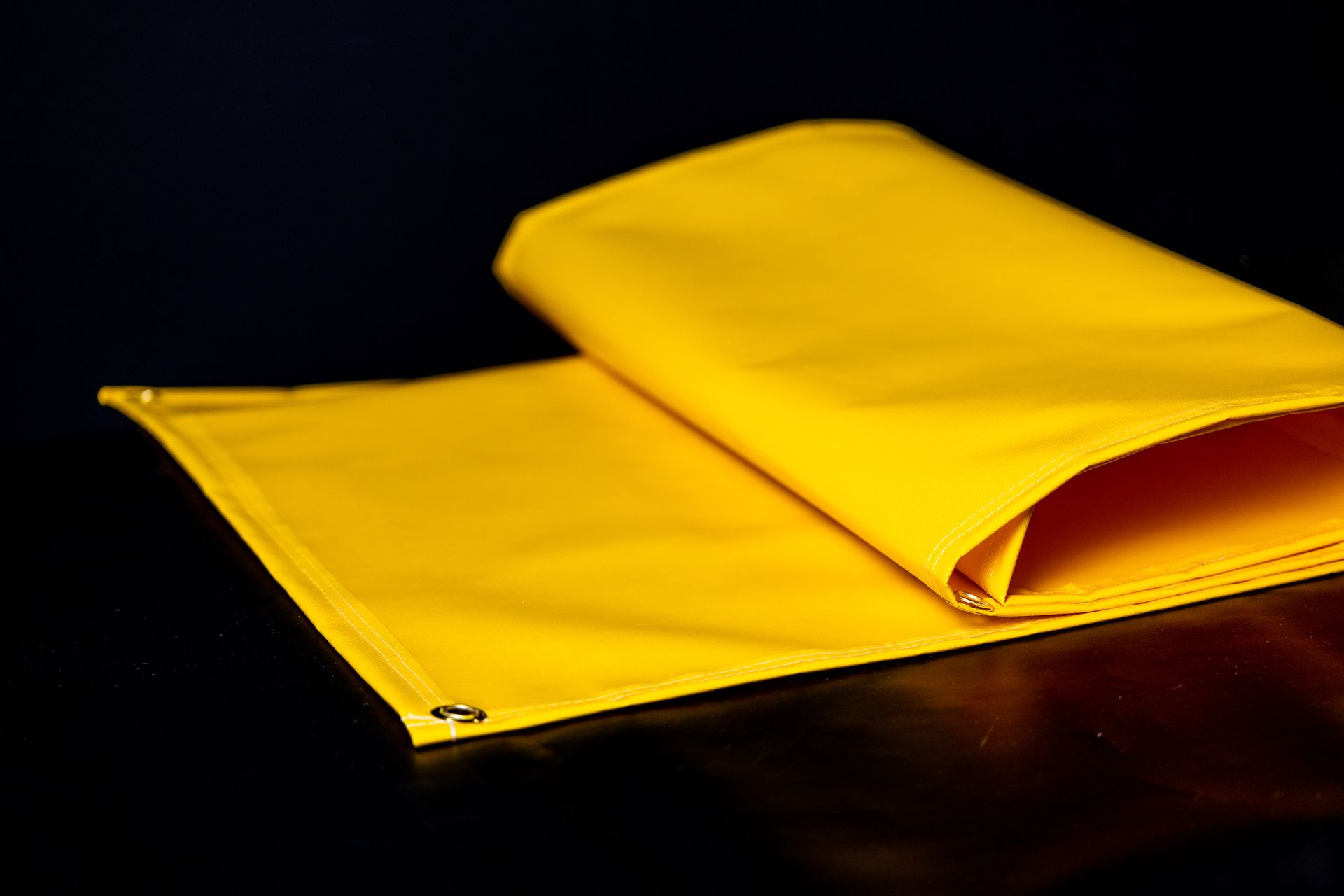 Yellow folded fabric on a dark surface