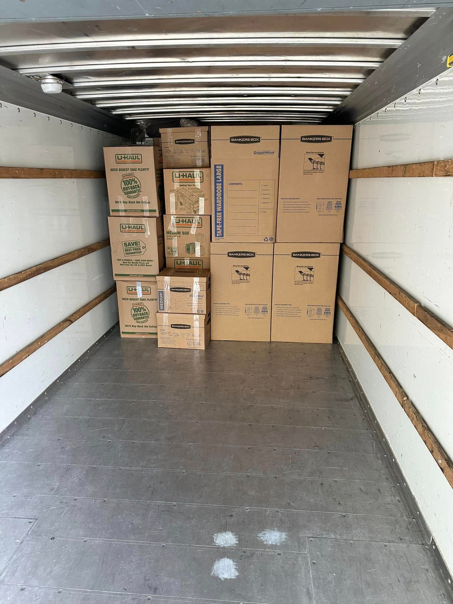 Boxes stacked inside a moving truck, ready for transport.