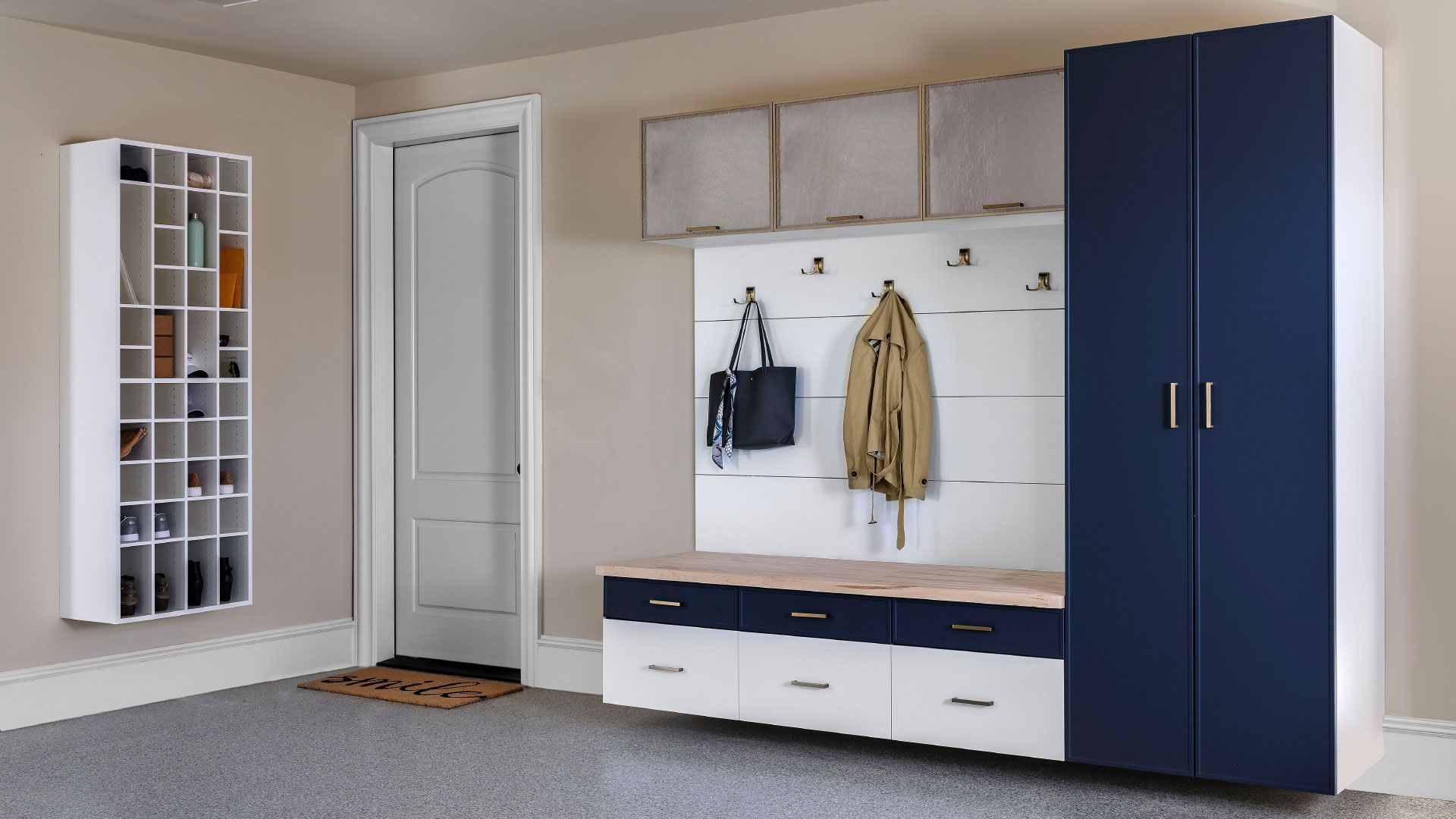 a room with blue and white cabinets and a bench .