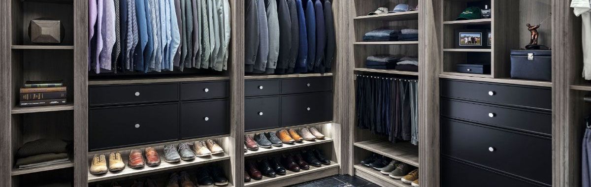 A walk in closet filled with lots of clothes and shoes.
