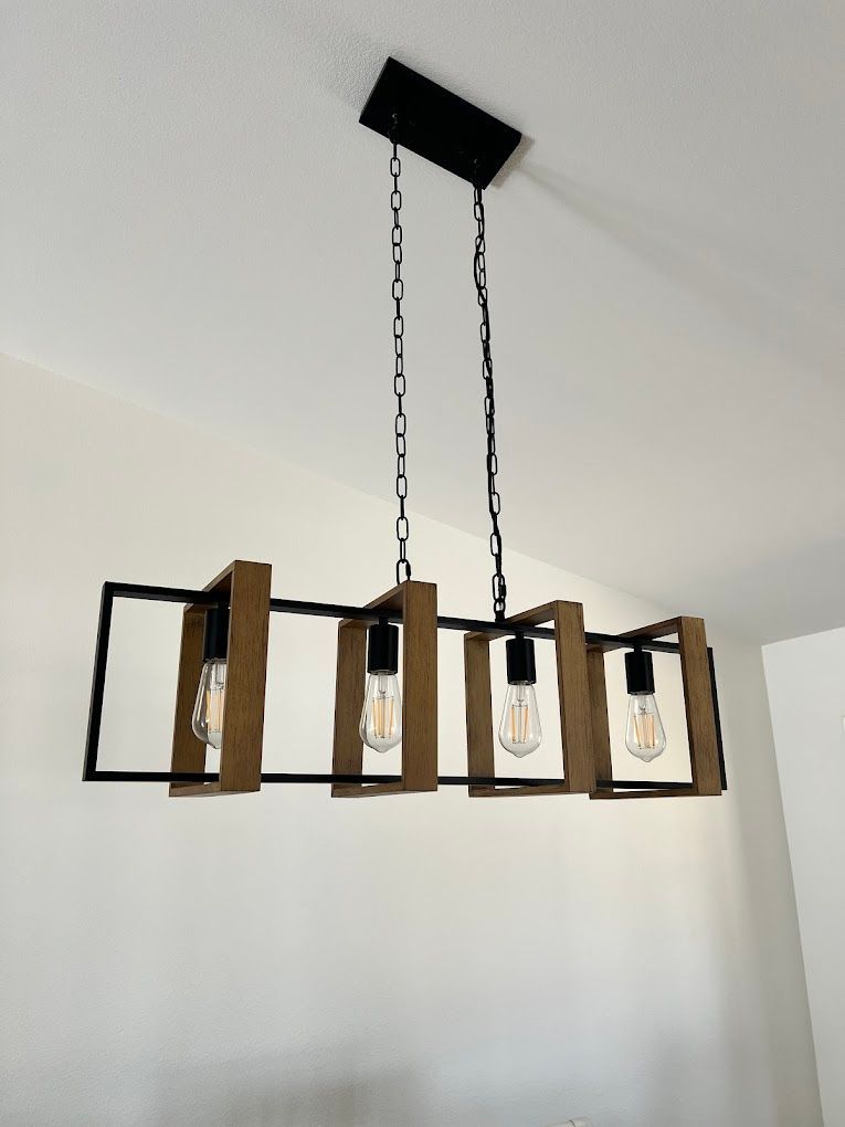 A light fixture made of wood and metal hanging from the ceiling