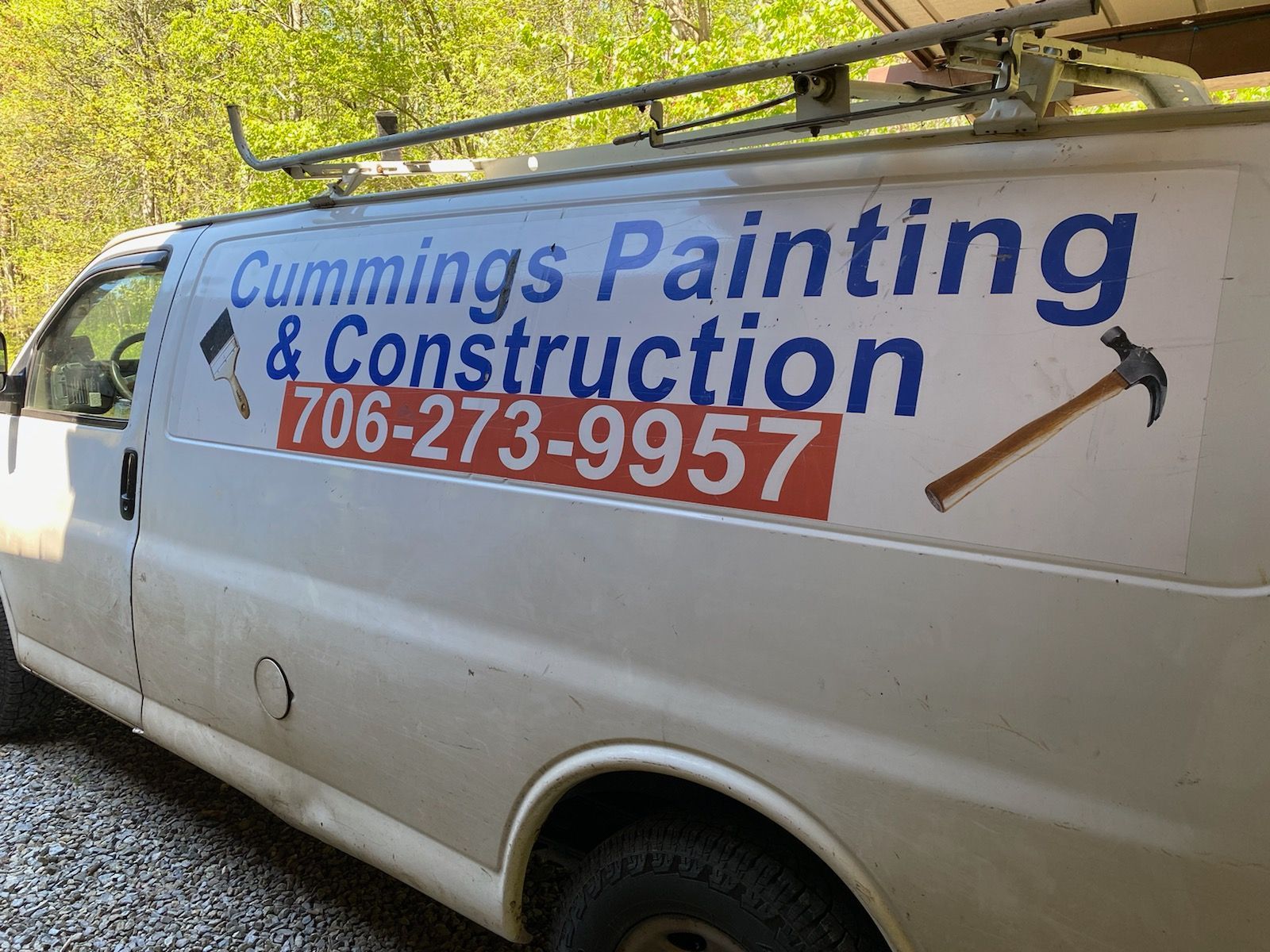 White work van with “Cummings Painting & Construction” and phone number 706-273-9957 on the side