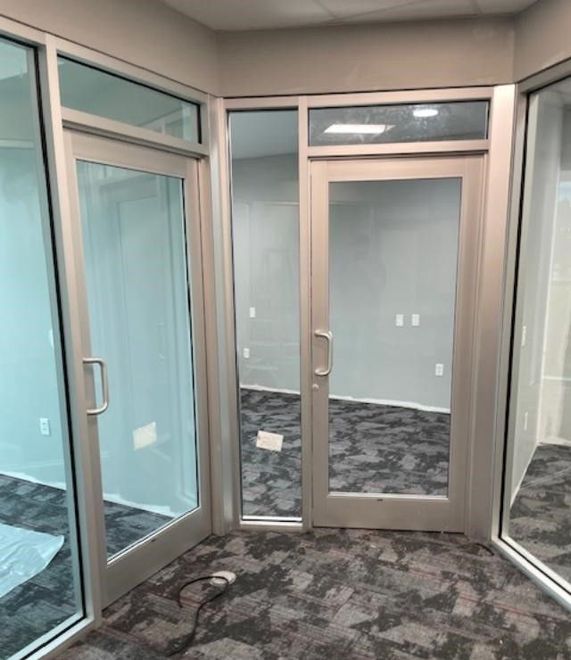 A room with a lot of windows and a door.