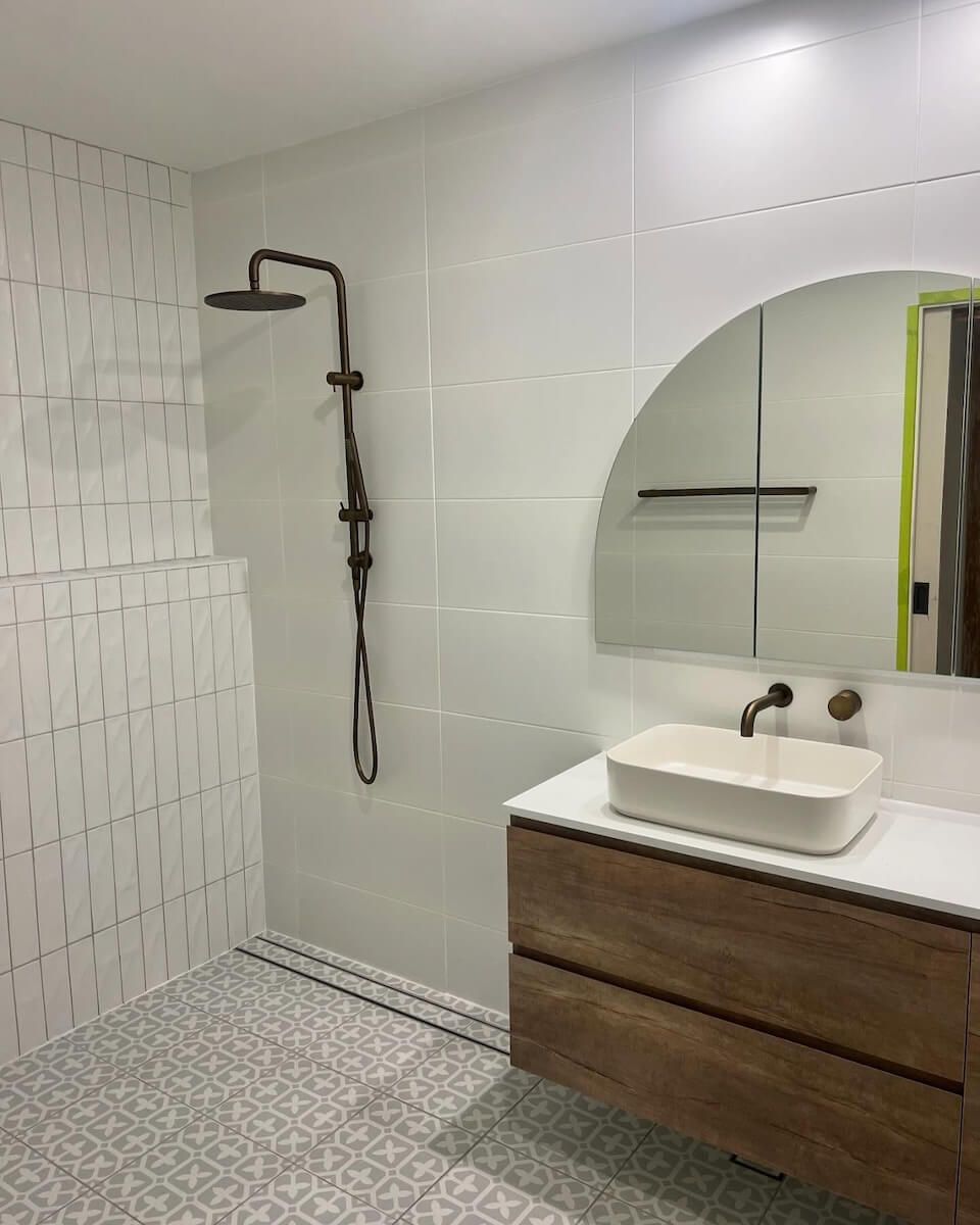A Bathroom With a Sink , Shower and Mirror — JMJ Plumbing and Electrical NSW In Tumbi Umbi, NSW