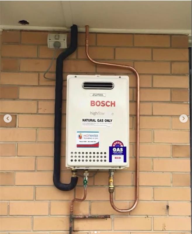 A Gas System is Attached to a Brick Wall — JMJ Plumbing and Electrical NSW In Tumbi Umbi, NSW