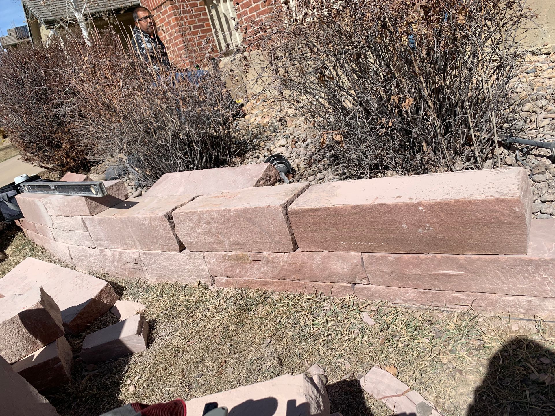 Red brick retaining wall being built in front yard.