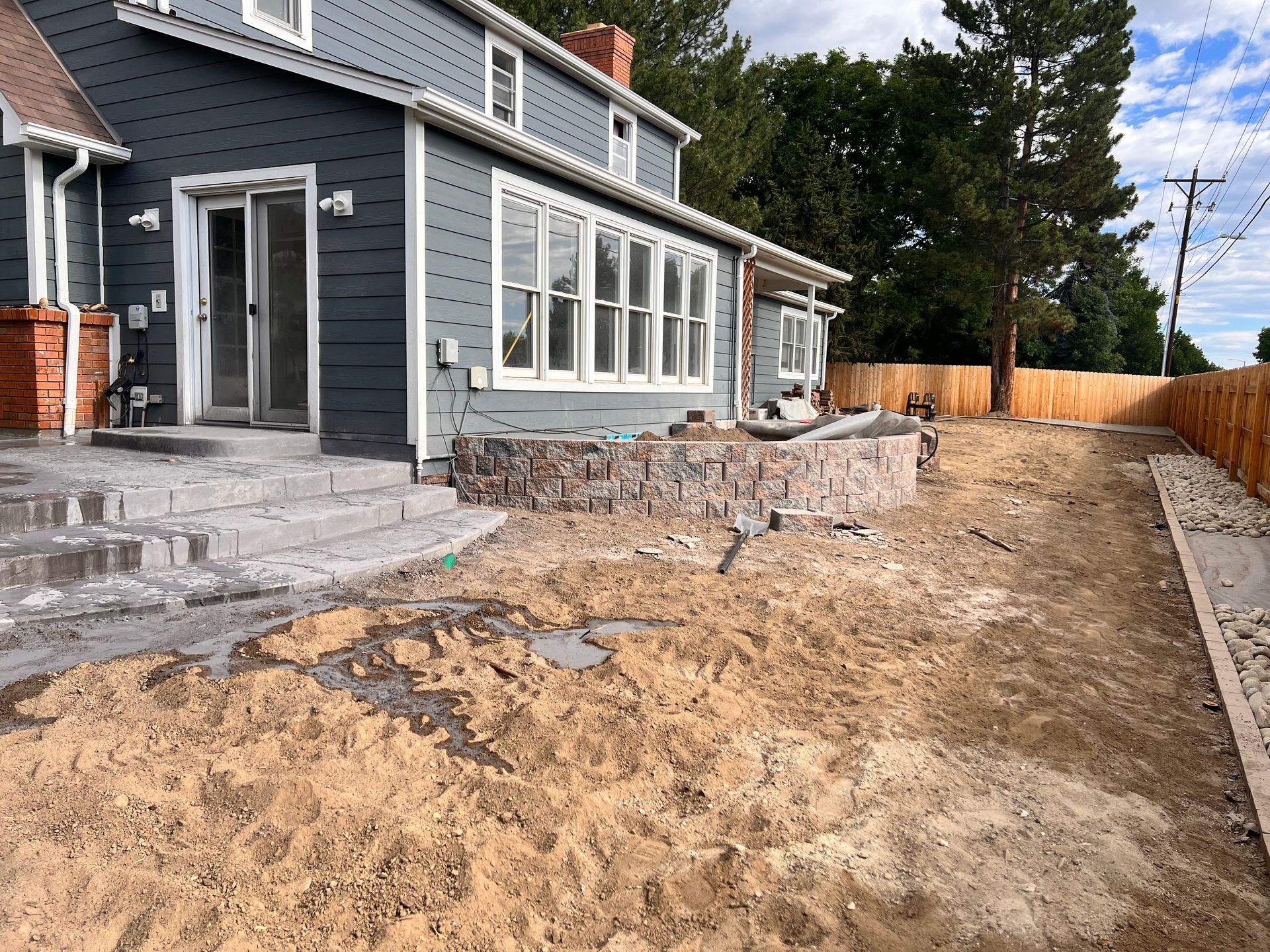 Backyard renovation with new steps, retaining wall, and sand ground.