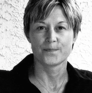 Woman with short hair, looking at the camera. Black and white photo with a textured background.