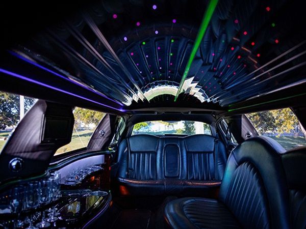 The inside of a limousine with a lot of lights on the ceiling.