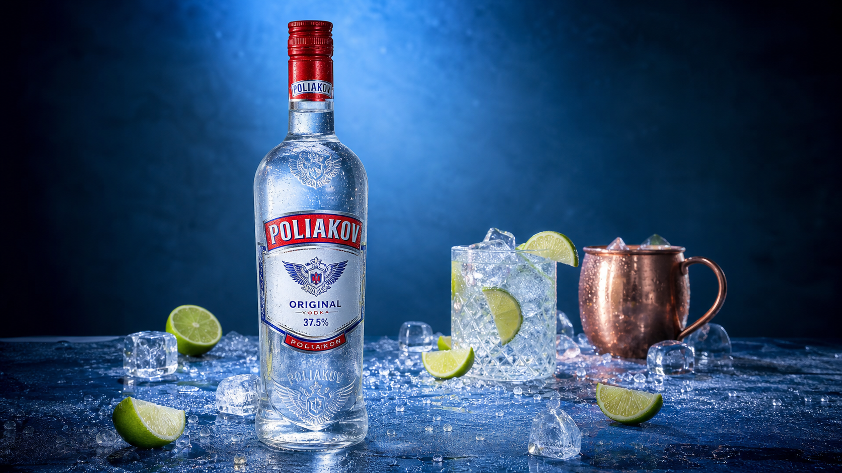 Silver bottle of Russian Standard vodka on ice with lime wedges and a copper mug against a blue background