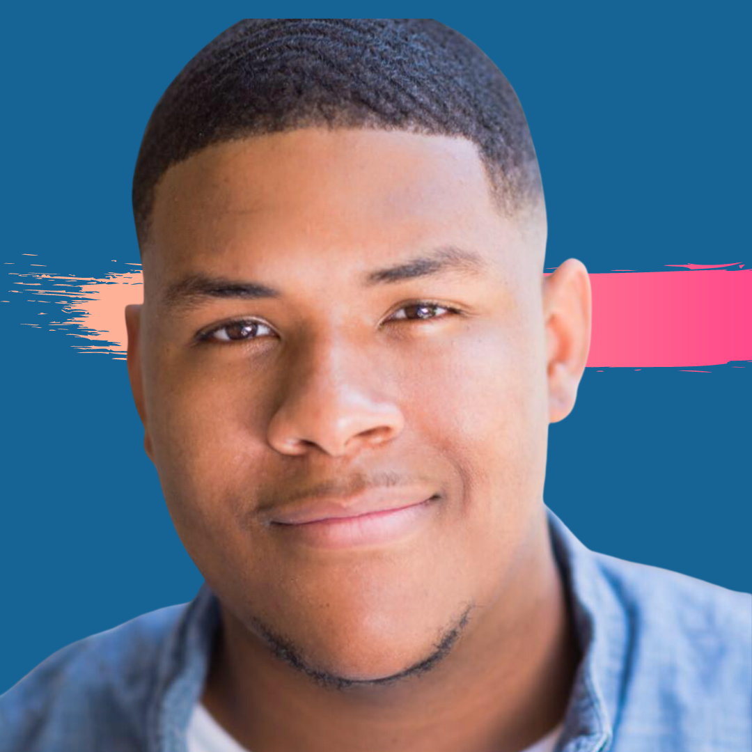 Smiling man with a fade haircut, wearing a denim shirt, with a blue and pink background.