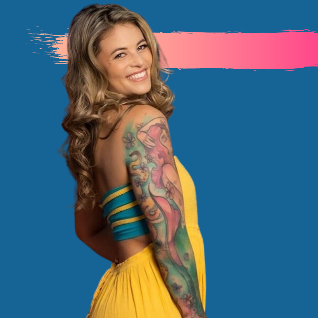Woman with arm tattoos smiles in yellow dress; blue and pink background.