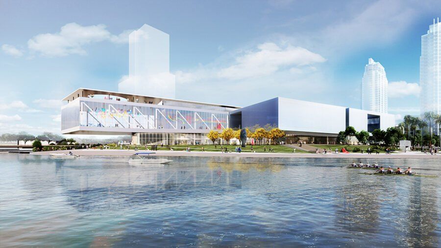 Rendering of a modern building by the water with glass and blue walls, people, and boats.