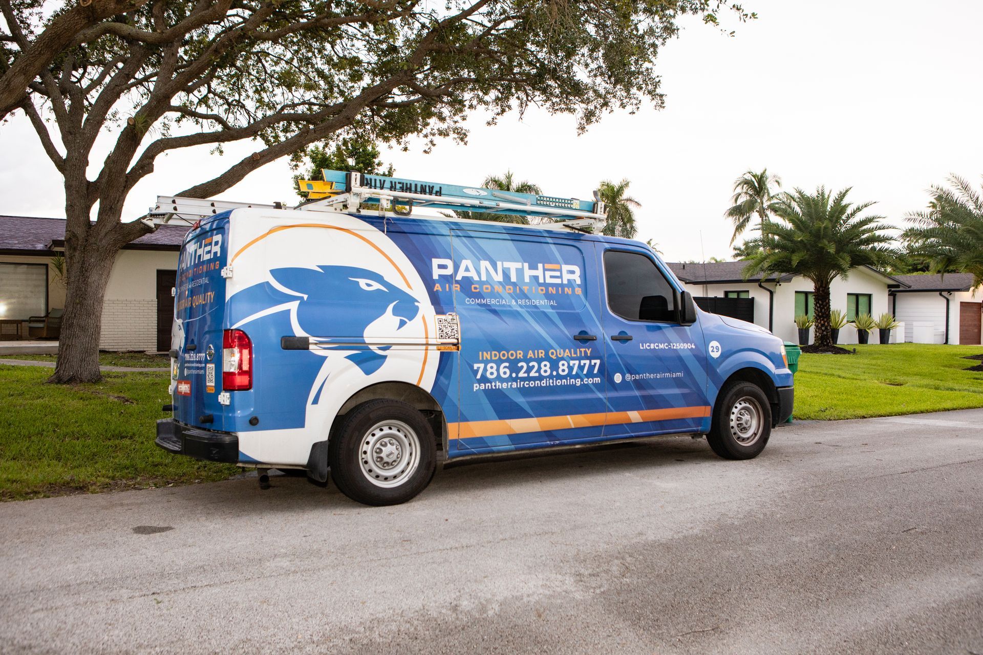A blue panther van is parked in a parking lot