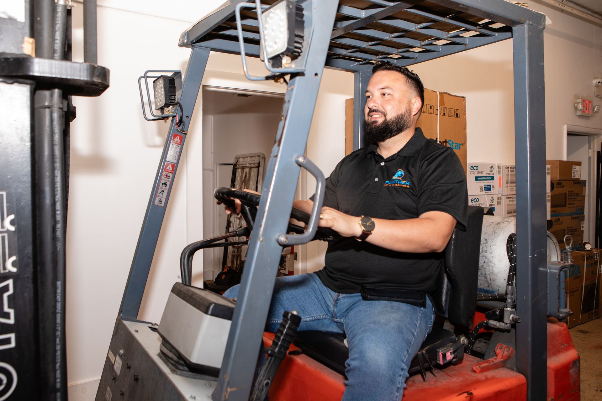 A man is working on an air conditioner in a room.