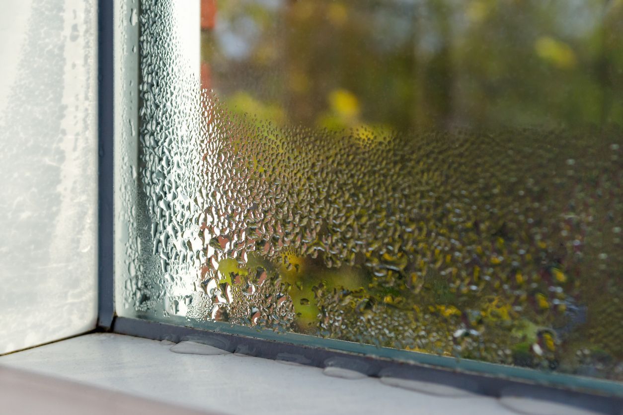 A close up of a window with condensation on it.