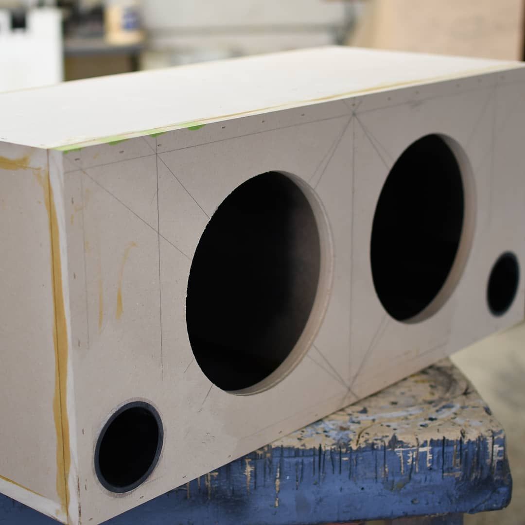 A white box with two black holes in it