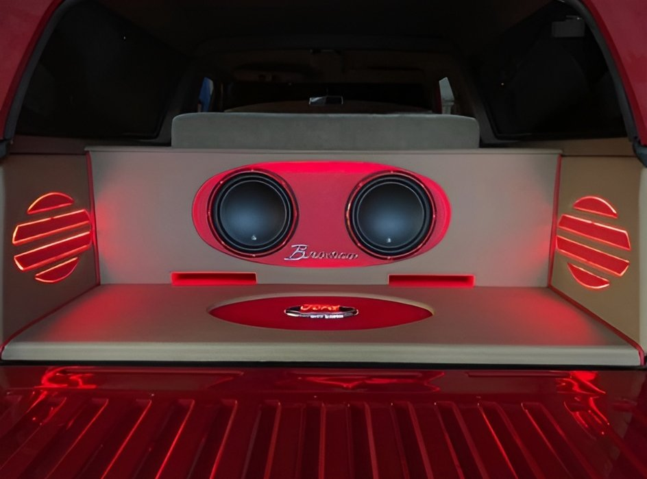 A harman kardon speaker is sitting on the dashboard of a car