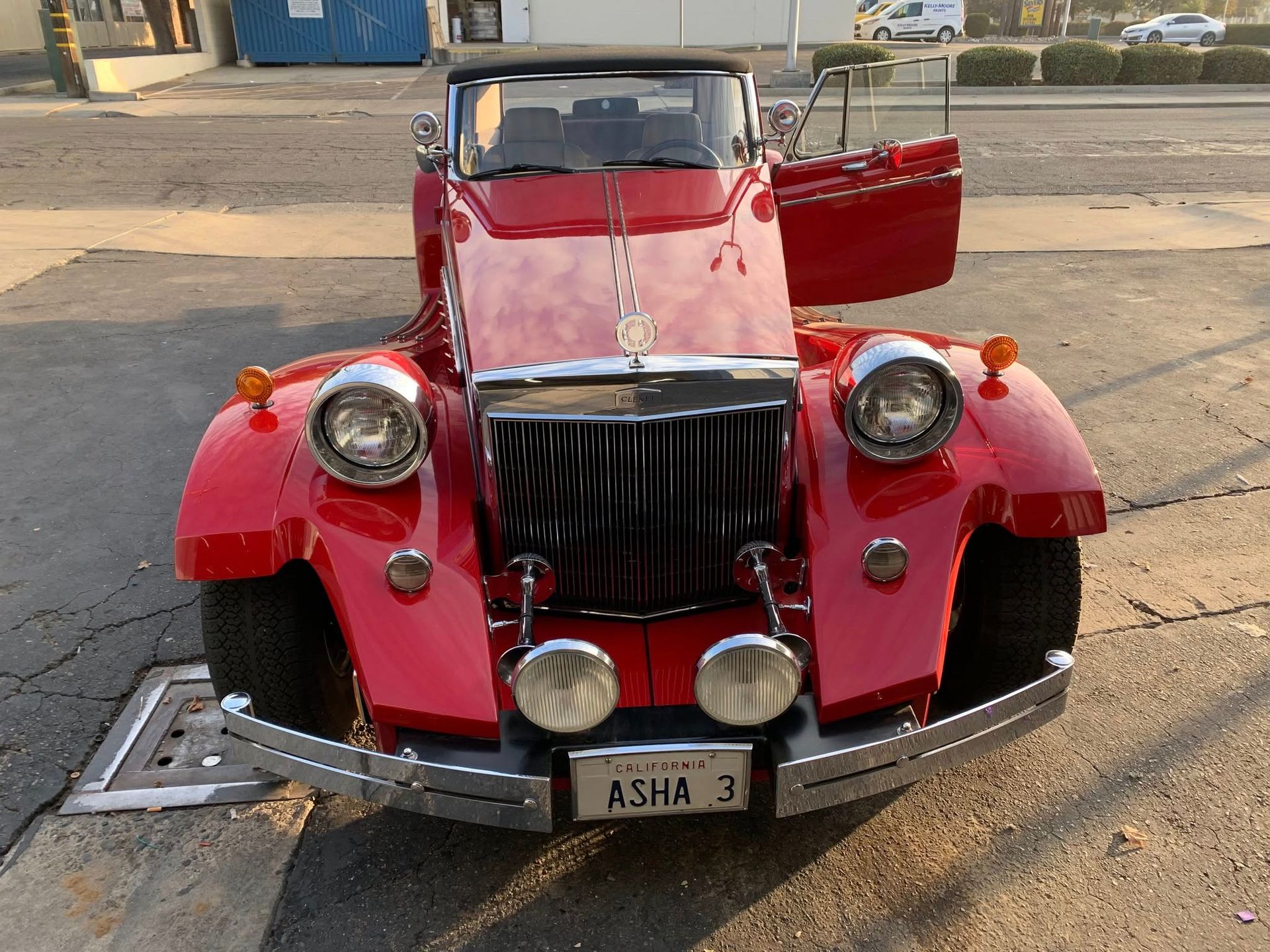 A red car with a license plate that says asha 3